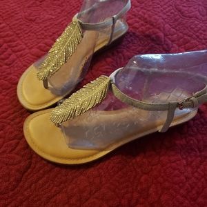 Carlos Santana gold feather thong sandals
